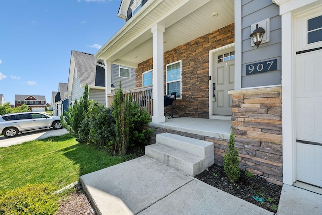 907 Caywood Rd, Smyrna, TN 37167 - doorway to property with covered porch, a yard, and stone siding