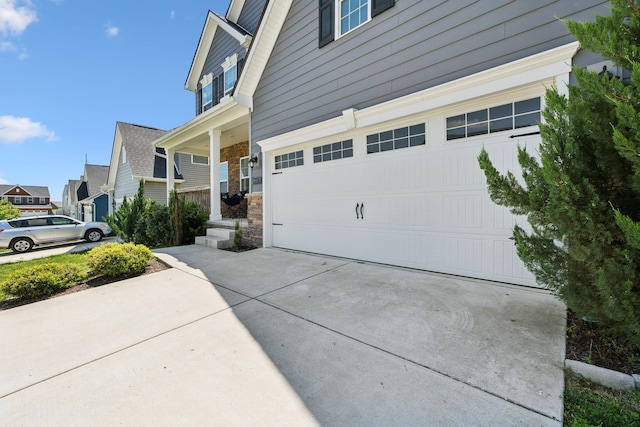 907 Caywood Rd, Smyrna, TN 37167 - view of property exterior with concrete driveway, an attached garage, and stone siding