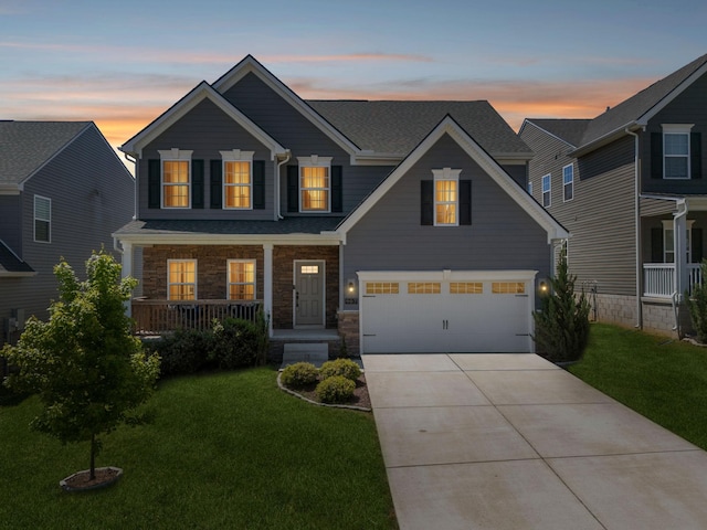 907 Caywood Rd, Smyrna, TN 37167 - view of front of home featuring concrete driveway, a garage, covered porch, and a front yard
