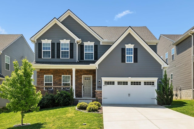 907 Caywood Rd, Smyrna, TN 37167 - view of front of property with covered porch, an attached garage, stone siding, concrete driveway, and a front yard