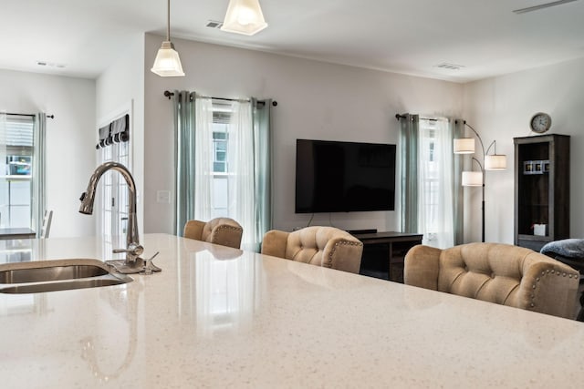 907 Caywood Rd, Smyrna, TN 37167 - kitchen with visible vents, light stone countertops, open floor plan, and a sink
