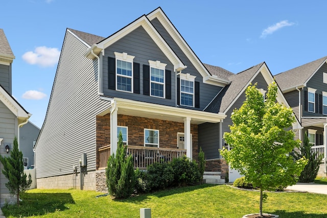 907 Caywood Rd, Smyrna, TN 37167 - craftsman-style house with stone siding, roof with shingles, covered porch, and a front yard