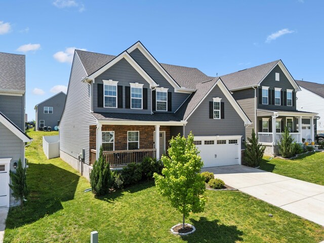 907 Caywood Rd, Smyrna, TN 37167 - view of front facade with driveway, a porch, a garage, and a front yard