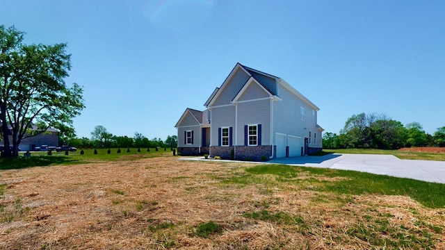 1150 Parsons Rd, Christiana, TN 37037 - view of side of home with concrete driveway, an attached garage, and a yard