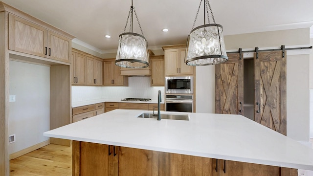 1150 Parsons Rd, Christiana, TN 37037 - kitchen with appliances with stainless steel finishes, a center island with sink, a sink, light countertops, and light brown cabinets