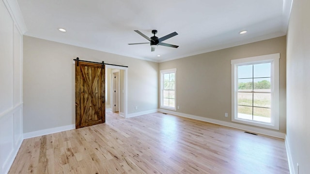1150 Parsons Rd, Christiana, TN 37037 - empty room featuring a barn door, baseboards, ceiling fan, and light wood-style flooring
