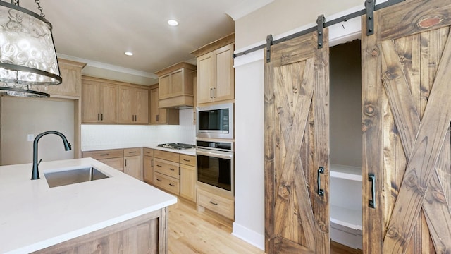 1150 Parsons Rd, Christiana, TN 37037 - kitchen with light brown cabinetry, light countertops, a barn door, a sink, and stainless steel appliances