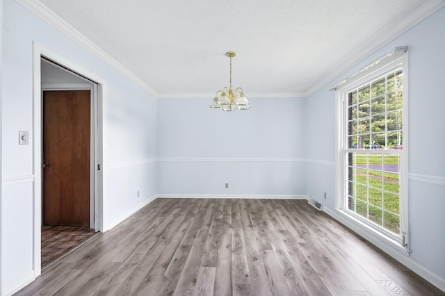 empty room featuring wood finished floors and a healthy amount of sunlight
