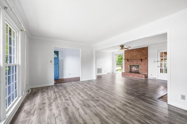 unfurnished living room with crown molding, a ceiling fan, wood finished floors, and visible vents