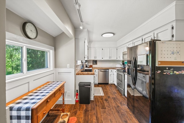 kitchen featuring dark wood-style flooring, light countertops, white cabinetry, a sink, and stainless steel appliances