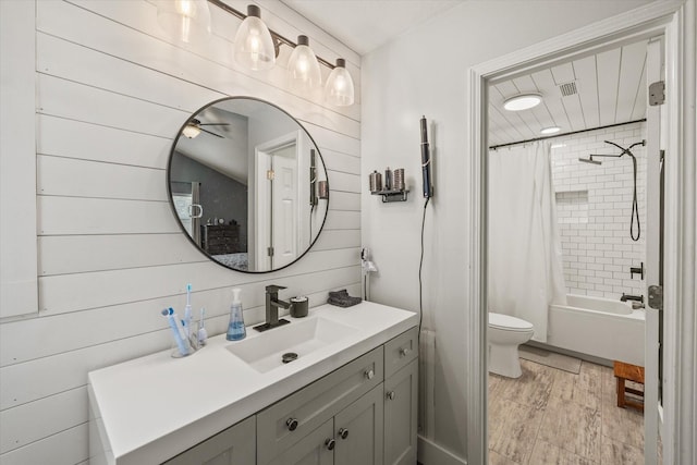 bathroom with toilet, shower / tub combo with curtain, and vanity