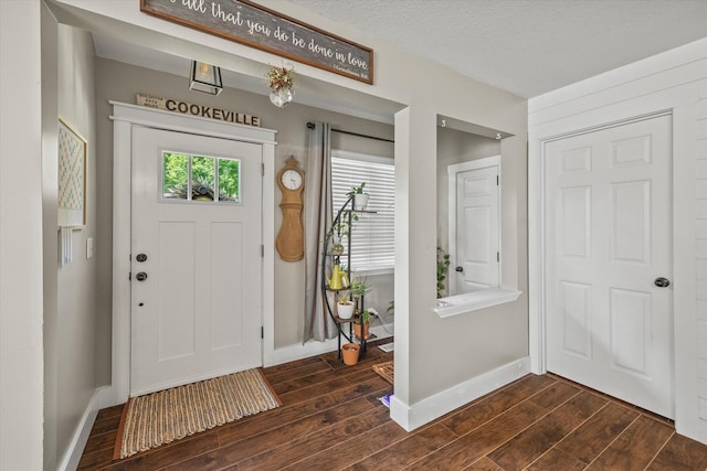 entrance foyer with baseboards and dark wood-style flooring