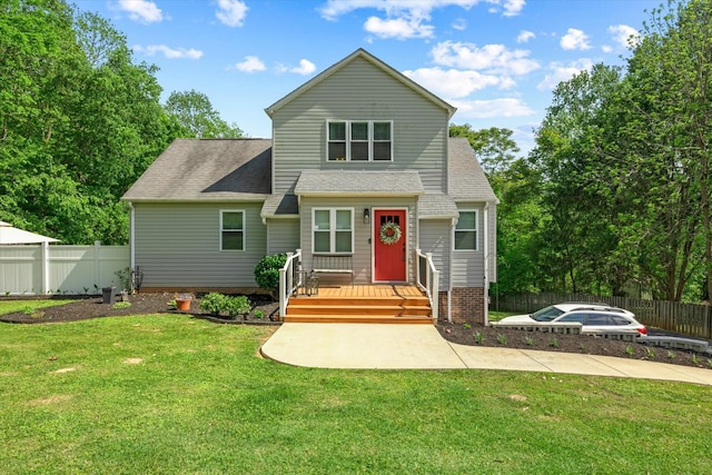 view of front of home with fence, a wooden deck, and a front yard