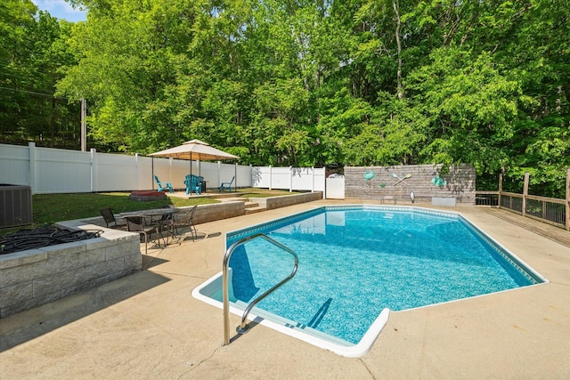 view of pool featuring a fenced in pool, a fenced backyard, a patio area, and cooling unit
