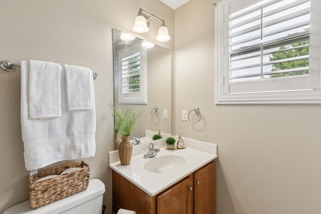 bathroom with vanity, plenty of natural light, and toilet