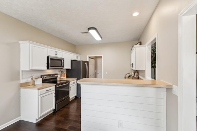 kitchen with recessed lighting, dark wood finished floors, white cabinetry, and stainless steel appliances