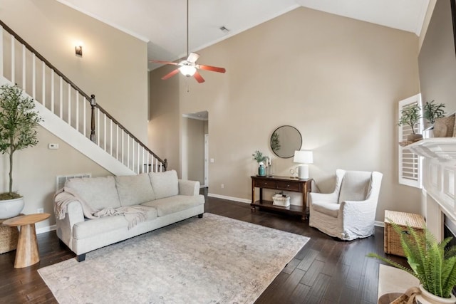 living room with high vaulted ceiling, stairs, a ceiling fan, baseboards, and dark wood-style floors