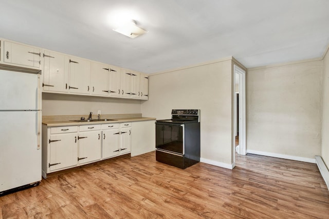 kitchen featuring freestanding refrigerator, black range with electric cooktop, light wood-type flooring, light countertops, and a sink
