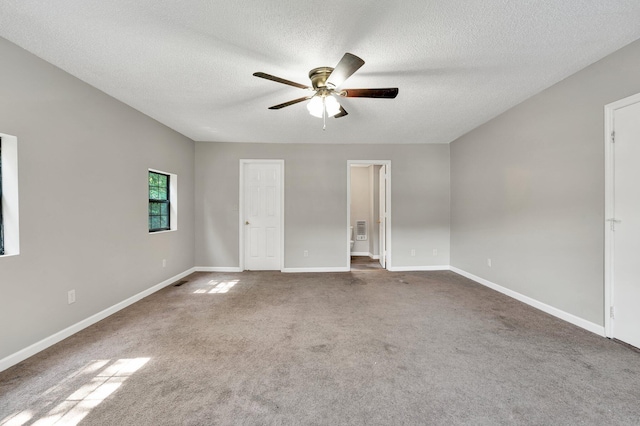 unfurnished bedroom with baseboards, carpet flooring, and a textured ceiling