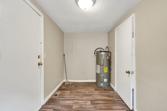 utility room with visible vents and electric water heater