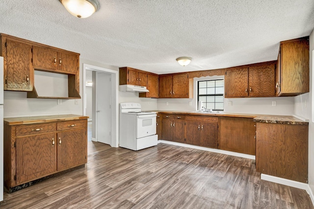 kitchen with under cabinet range hood, white electric range, brown cabinets, and dark wood-type flooring