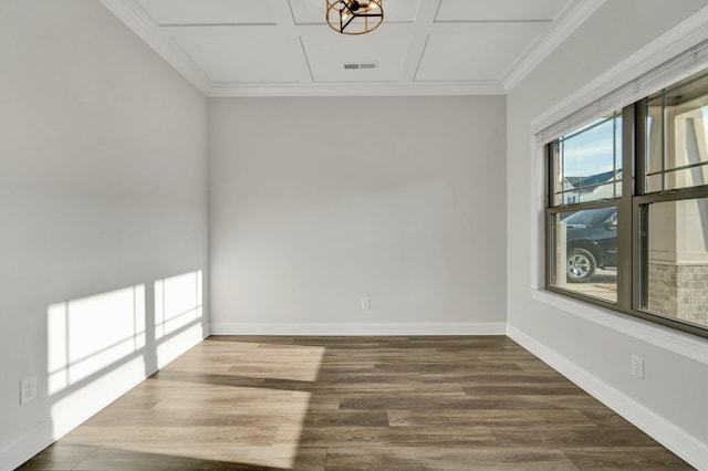 unfurnished room featuring visible vents, ornamental molding, baseboards, and wood finished floors