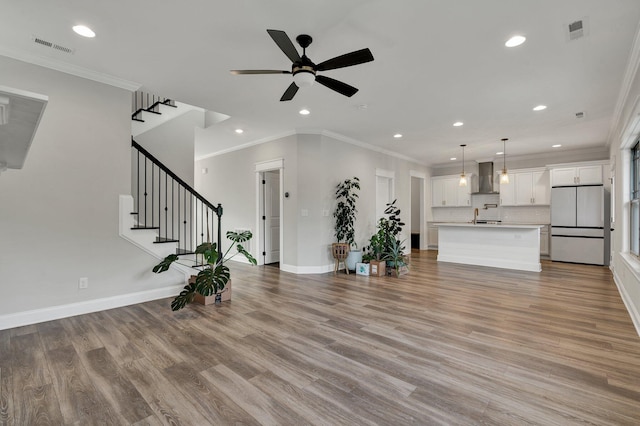 unfurnished living room featuring a ceiling fan, visible vents, and recessed lighting