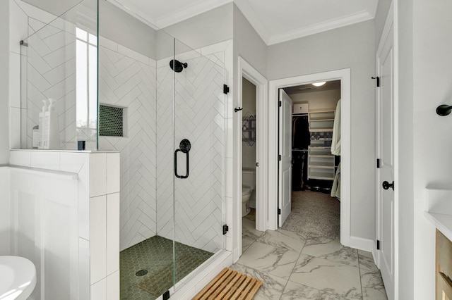 bathroom featuring a walk in closet, a stall shower, toilet, marble finish floor, and ornamental molding