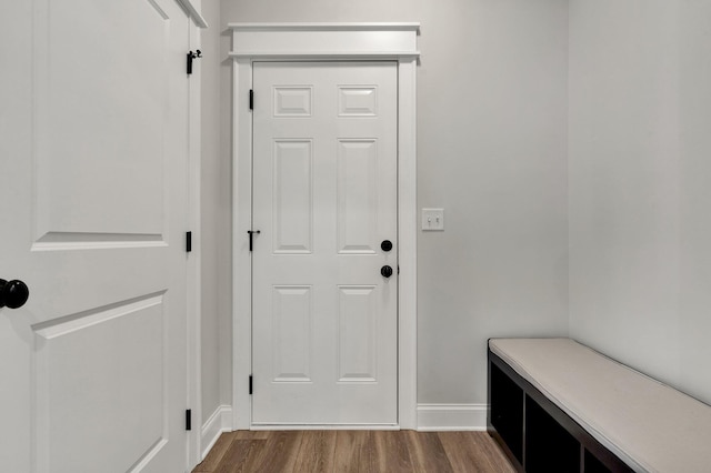 entryway featuring baseboards and dark wood finished floors