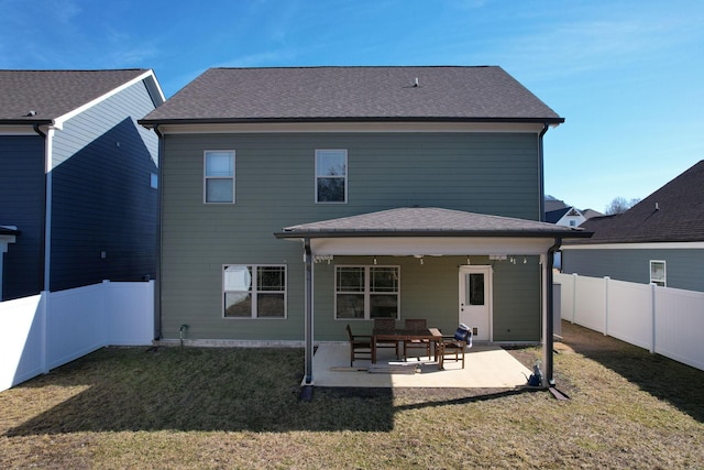 back of house with a fenced backyard, a yard, and a patio area