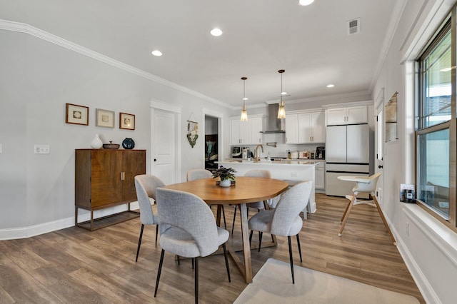 dining room featuring recessed lighting, visible vents, and wood finished floors