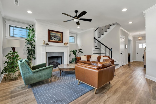 living area with ceiling fan, visible vents, wood finished floors, stairway, and baseboards