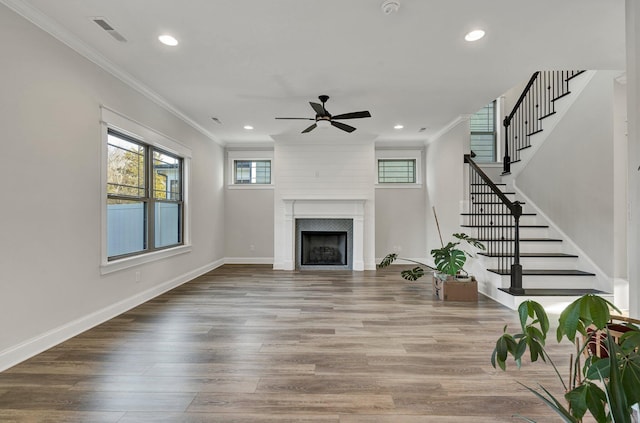 living area with a ceiling fan, recessed lighting, wood finished floors, visible vents, and ornamental molding