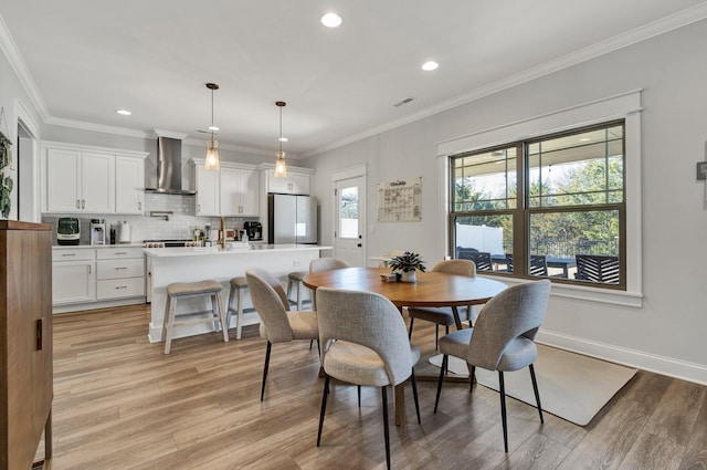 dining area with recessed lighting, visible vents, ornamental molding, and light wood finished floors