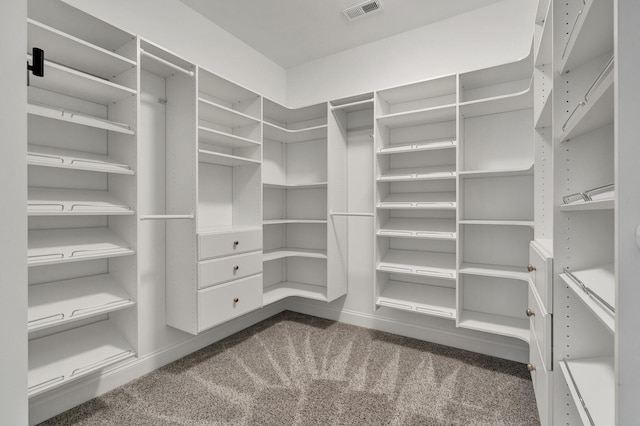 walk in closet with dark carpet and visible vents