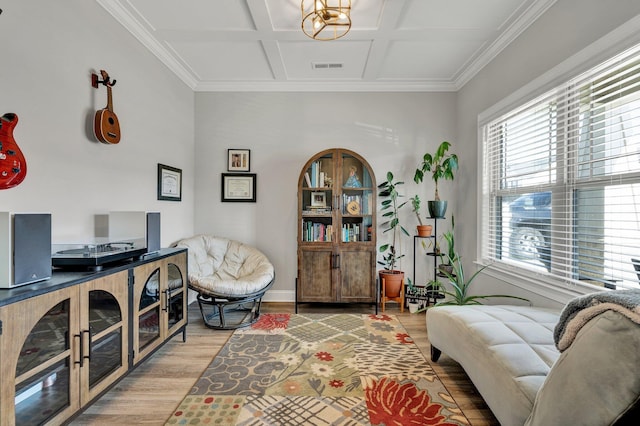 interior space featuring crown molding, coffered ceiling, light wood finished floors, and visible vents
