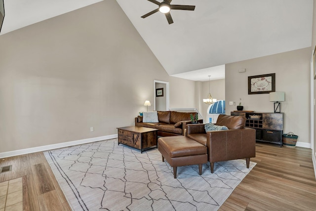 8581 Flowerdale Dr, Chattanooga, TN 37421 - living room featuring light wood-style floors, high vaulted ceiling, ceiling fan with notable chandelier, baseboards, and visible vents