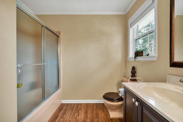 1922 W Brookhaven Cir, Dalton, GA 30720 - bathroom featuring crown molding, vanity, toilet, wood finished floors, and bath / shower combo with glass door
