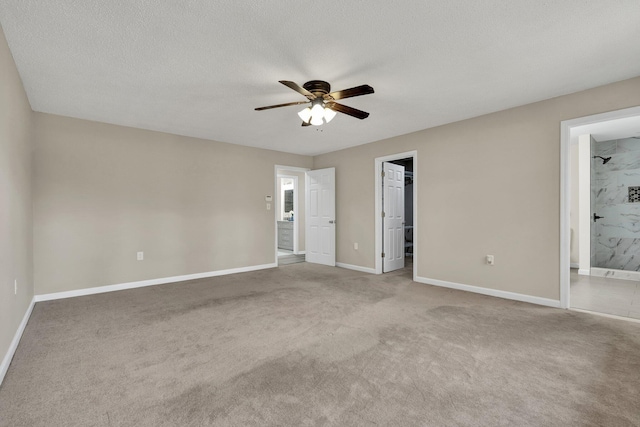 3839 Cleveland Hwy, Dalton, GA 30721 - unfurnished bedroom with baseboards, carpet flooring, a spacious closet, ensuite bathroom, and ceiling fan