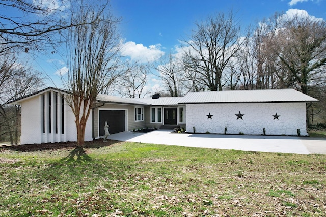 3839 Cleveland Hwy, Dalton, GA 30721 - back of property with a garage, a lawn, concrete driveway, and a chimney