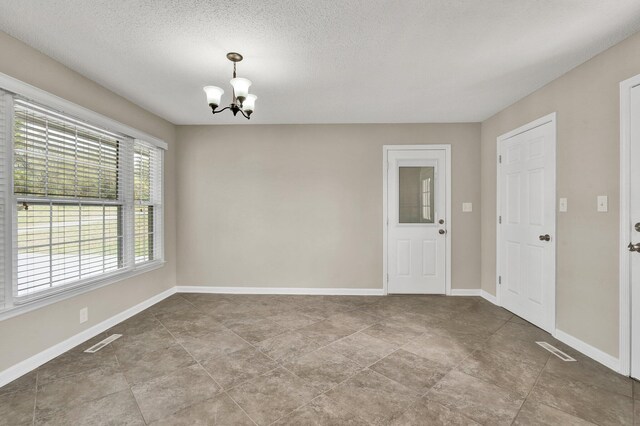 3839 Cleveland Hwy, Dalton, GA 30721 - unfurnished room featuring a chandelier, baseboards, a textured ceiling, and tile patterned floors