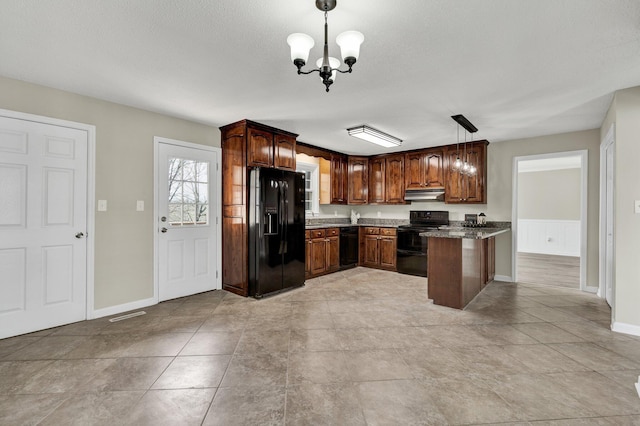 3839 Cleveland Hwy, Dalton, GA 30721 - kitchen with black appliances, under cabinet range hood, a chandelier, and hanging light fixtures