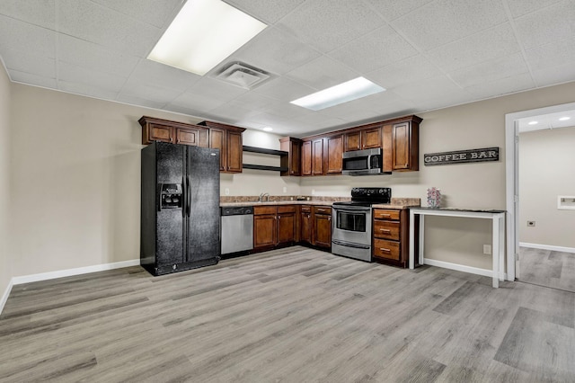 3839 Cleveland Hwy, Dalton, GA 30721 - kitchen featuring stainless steel appliances, light wood-style flooring, a sink, baseboards, and light countertops