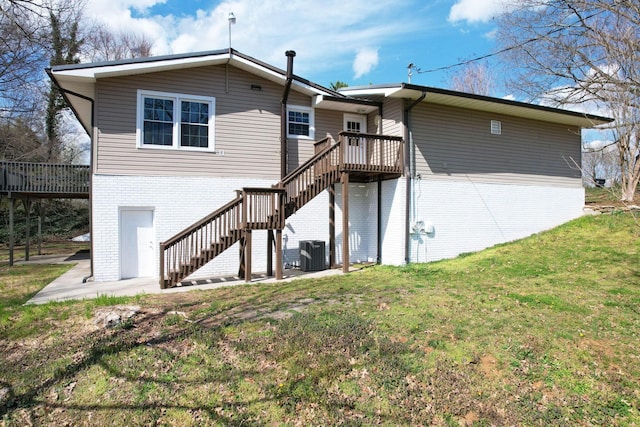 3839 Cleveland Hwy, Dalton, GA 30721 - back of property featuring stairway, central AC unit, brick siding, and a deck