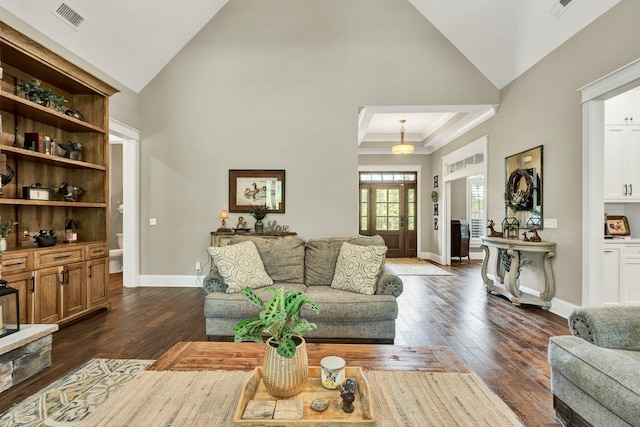 living area with baseboards, visible vents, dark wood finished floors, and high vaulted ceiling