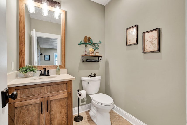 bathroom with vanity, baseboards, and toilet