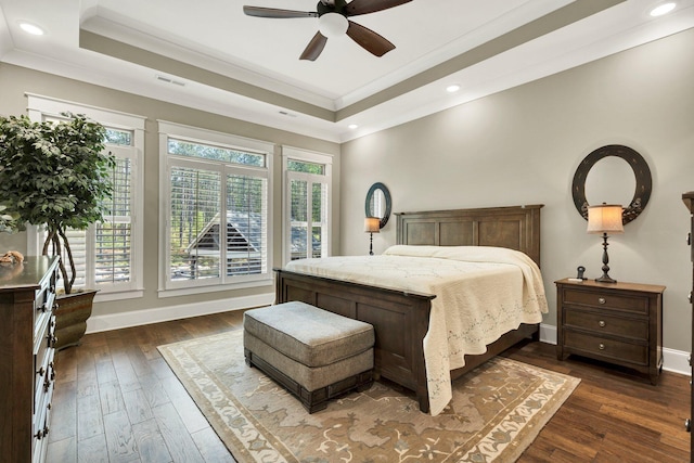bedroom featuring multiple windows, ornamental molding, a tray ceiling, and visible vents