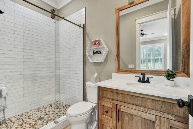 bathroom with a ceiling fan, crown molding, a stall shower, vanity, and toilet