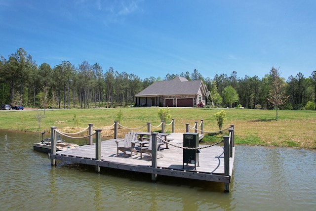 dock area with a lawn and a water view