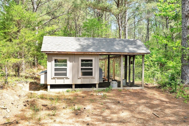 view of poultry coop featuring a view of trees